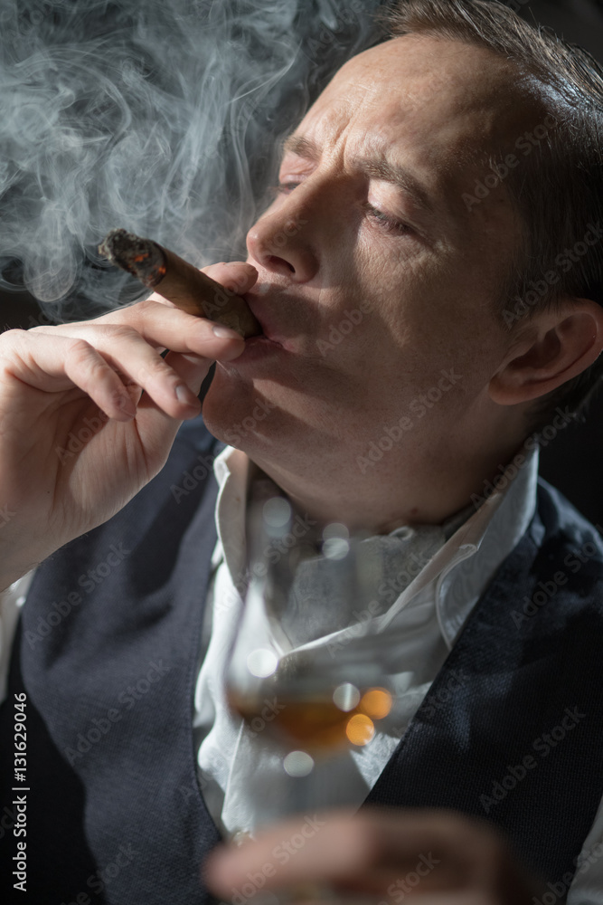 Fototapeta premium Man holding a cigar in his mouth