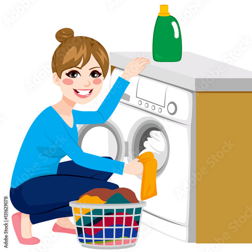 Beautiful young woman doing laundry putting dirty clothes on washing machine from basket
