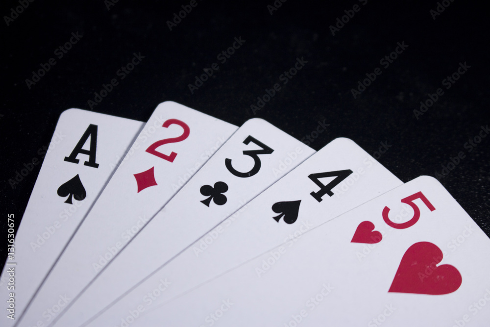 straight poker card on dark black background straight poker card on dark black background