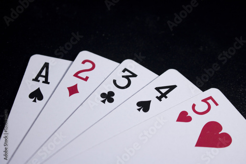 straight poker card on dark black background