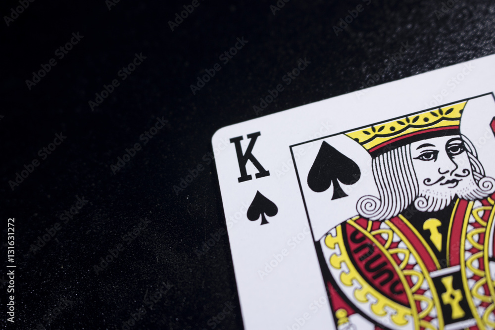 king poker card on dark black background