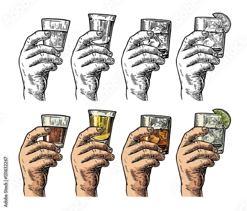 Male hand holding a glasses with tequila, rum, whiskey and ice cubes.