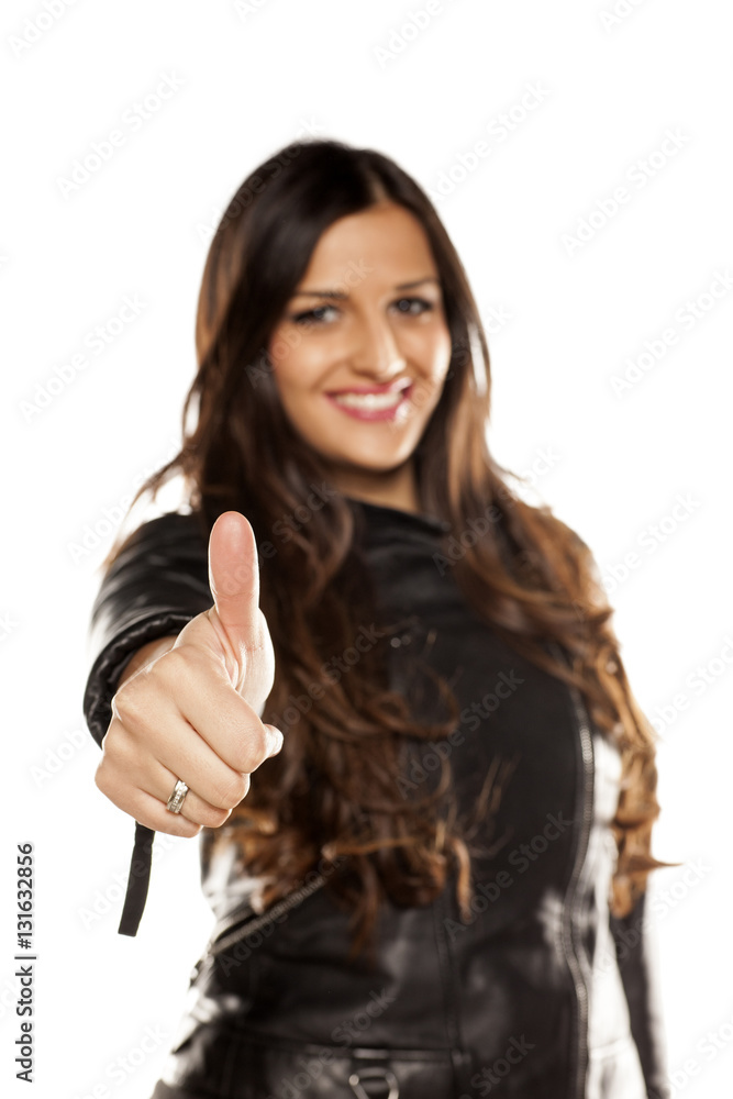 pretty girl in a leather jacket showing thumbs up pretty girl in a leather jacket showing thumbs up