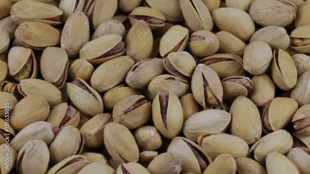 Dried roasted salted appetizing pistachios rotating, close up Dried roasted salted appetizing pistachios rotating, close up