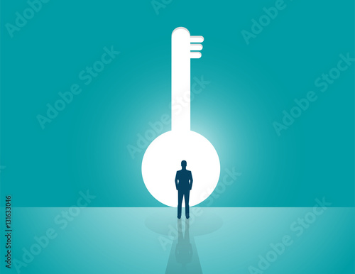 Businessman looking a big key