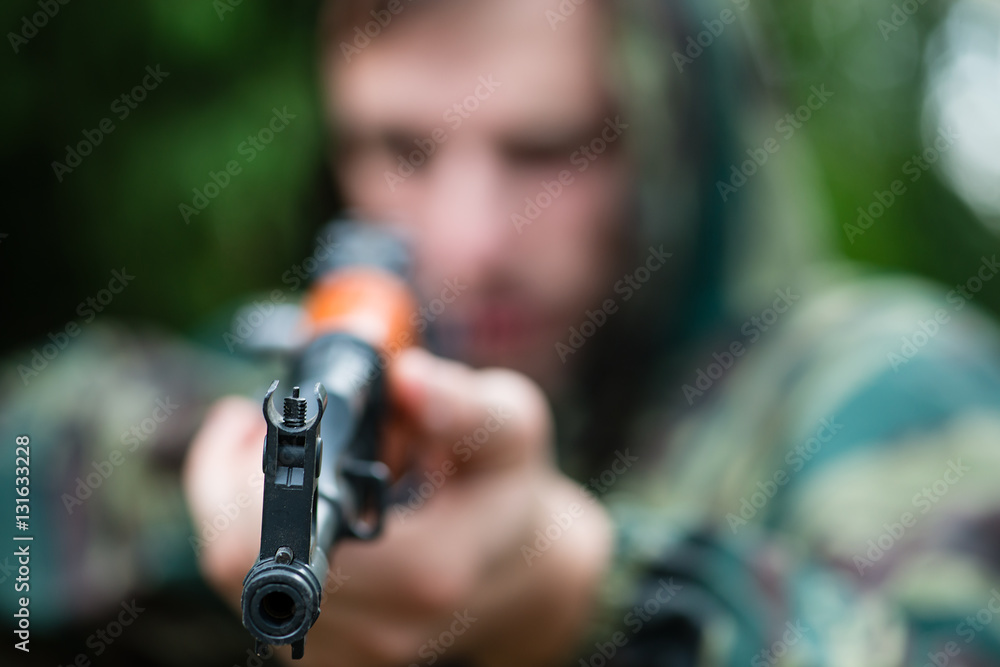 Armed soldier in camouflage with a Kalashnikov assault rifle, so Armed soldier in camouflage with a Kalashnikov assault rifle, so