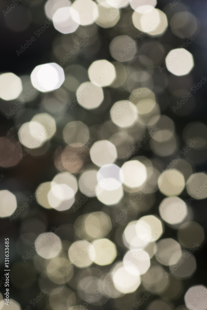 Obraz premium Christmas background has beautiful colored bokeh. Blurry texture of a lit garland for holiday. 