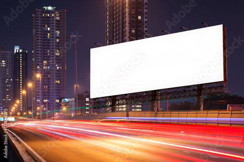Blank billboard on light trails, street and urban in the night - can advertisement for display or montage product or business.