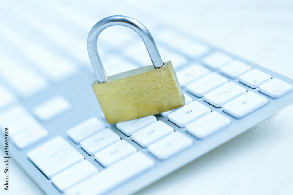 Security lock on white computer keyboard Security lock on white computer keyboard