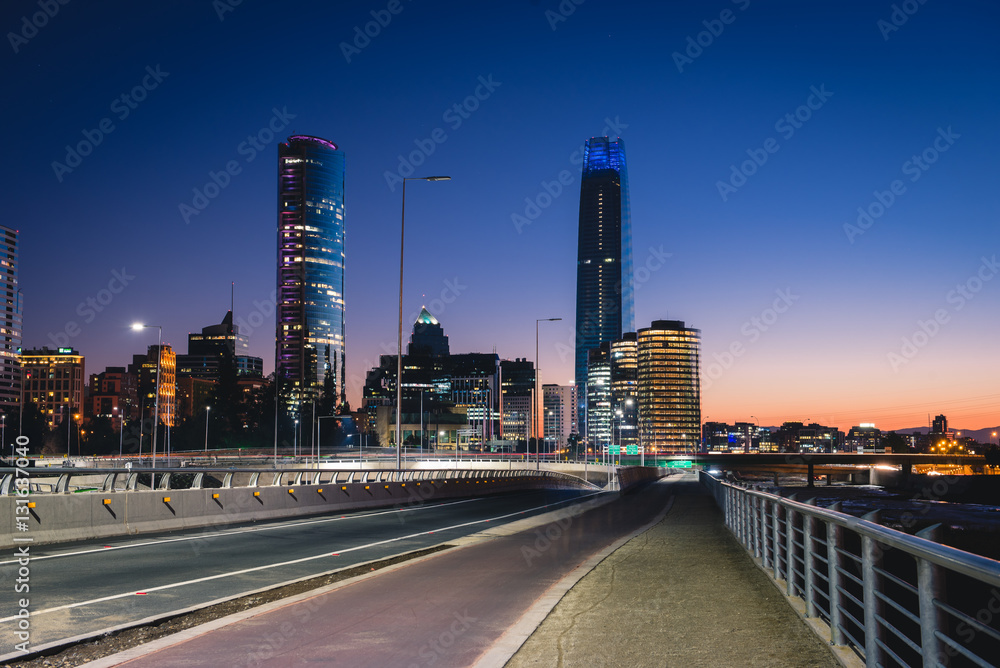 Fototapeta premium Beautiful view to road and illuminated skyscrapers in Santiago, Chile. Horizontal outdoors shot