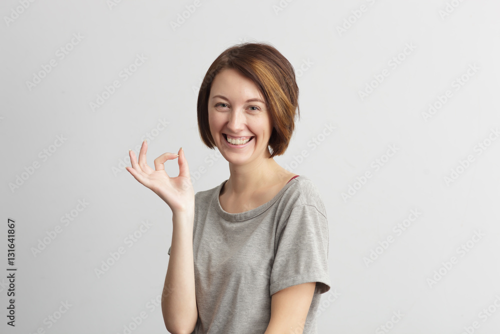 girl shows sign okay, pleased with the success or luck girl shows sign okay, pleased with the success or luck