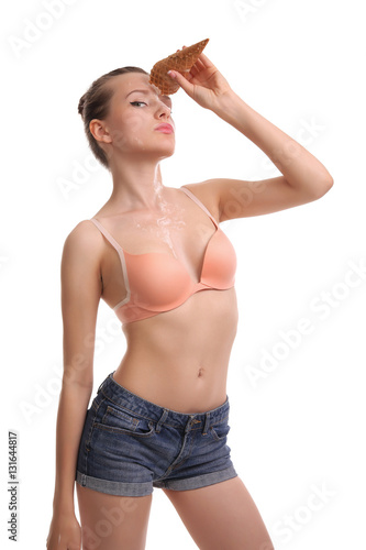 beautiful woman eats icecream in studio , ice cream dripping on the face and breast girl.