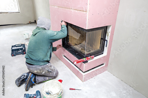 Fireplace installing. Fireplace made from Calcium Silicate Fire Protective Board. Installation of Stone on Fireplace photo