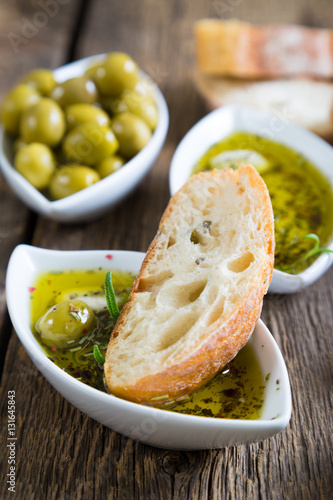 The bread dipped in olive oil with herbs and spices