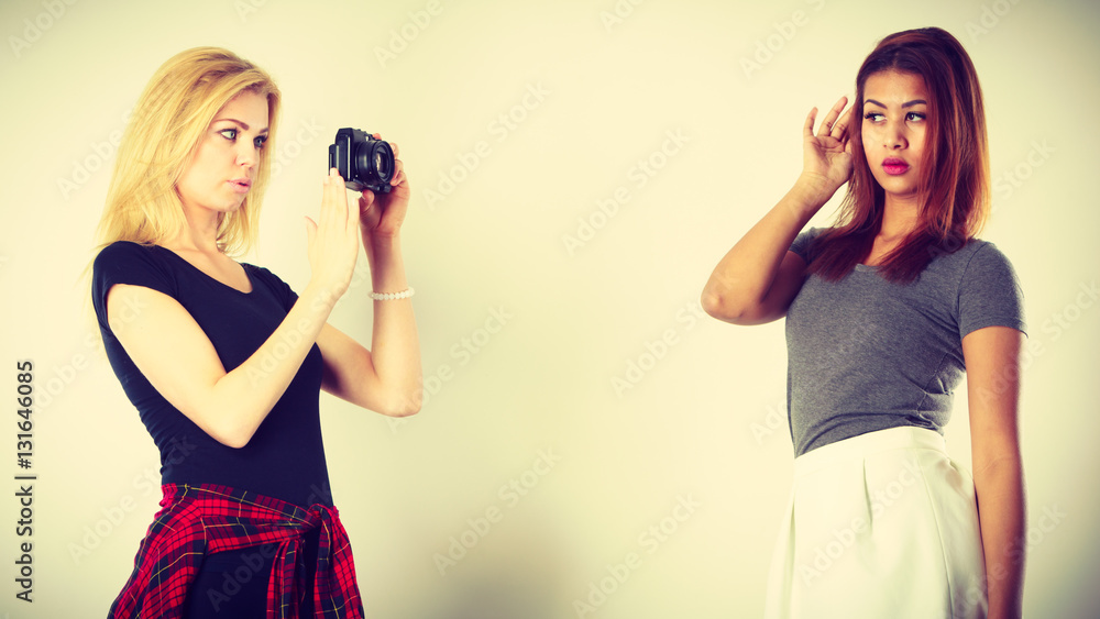 Blonde girl photographing woman Blonde girl photographing woman