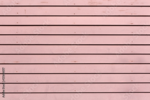 Rows of red painted clapboard siding