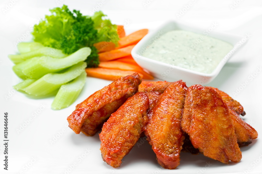 Fried chiken wings with fresh vegetables isolated on white Fried chiken wings with fresh vegetables isolated on white