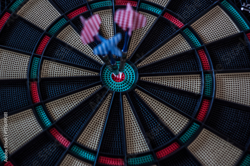 Three darts in the center of a target close up