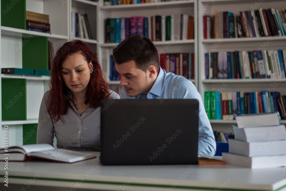 Handsome brunette guy and beautiful redhead student girl serious Handsome brunette guy and beautiful redhead student girl serious