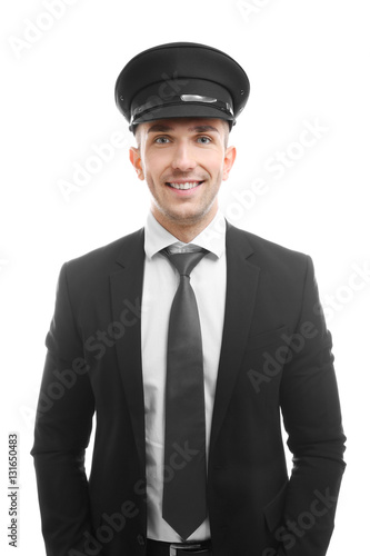 Young chauffeur standing on white background © Africa Studio