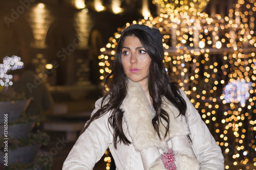 beautiful sad woman alone on the street on new year.Night outdoor scene