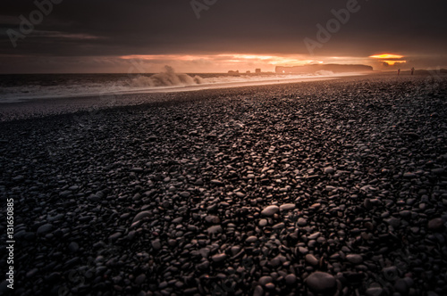 Black sand beach on sunset called Reynisfjara in south coast of Iceland