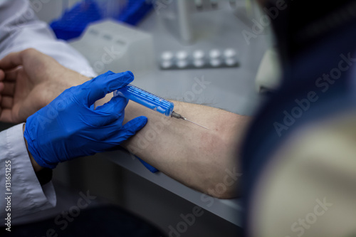 Wallpaper Mural Doctor or scientist inject a needle in patient's arm Torontodigital.ca