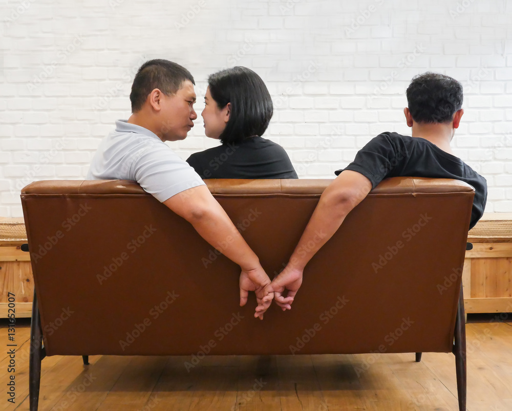 Back scene of two man with one women sitting on sofa, sign of love triangle  Stock Photo | Adobe Stock