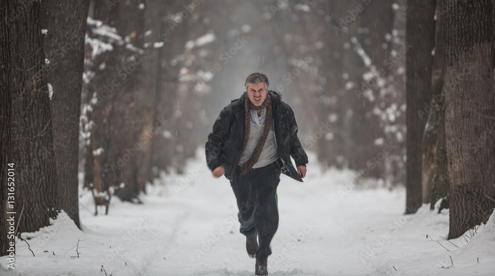 man runs on a snowy alley