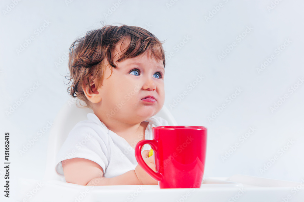 Happy baby boy sitting and eating Happy baby boy sitting and eating