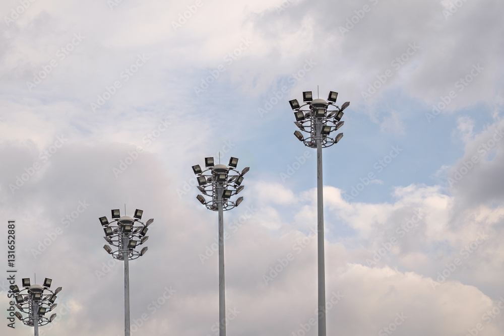 Spotlights / Spotlights tower on blue sky background. Spotlights / Spotlights tower on blue sky background.
