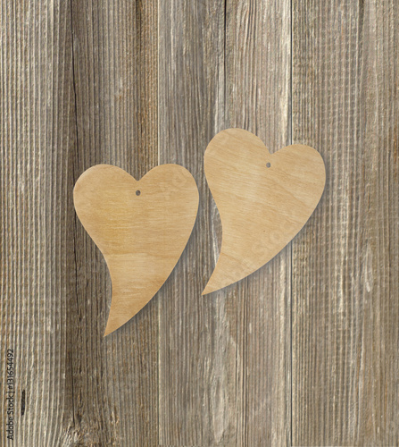 Two wooden hearts on a wooden background. Top view. Valentines days. Love symbol. Greeting card.Vintage style. Greeting card.