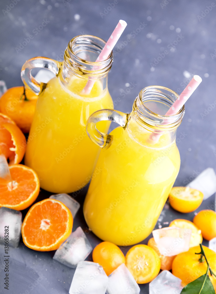 Bottle of Freshly squeezed citrus juice Fruit slice Ice Bottle of Freshly squeezed citrus juice Fruit slice Ice