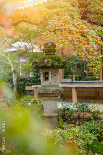 Japan Nature Park with stone lantern. Japanese garden with colorful red maple in autumn season travel location of Kyoto Osaka Prefecture in Kansai Region