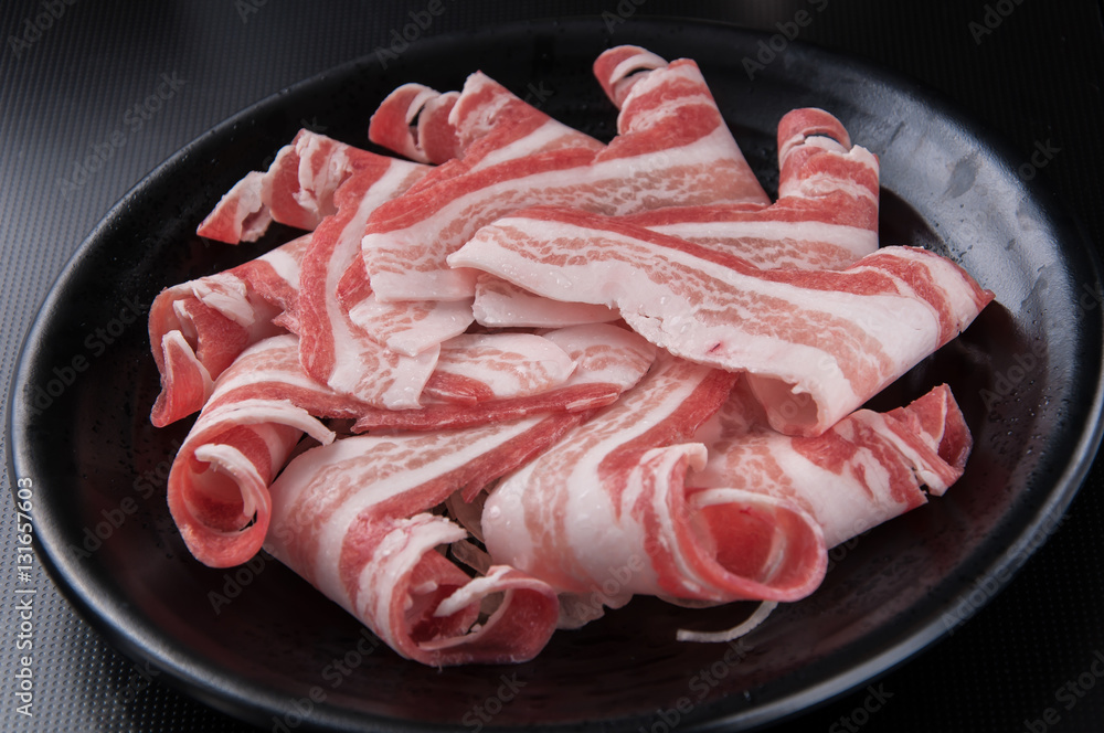 Raw Ground beef meat Burger steak cutlets with seasoning on vintage metal tray, black background Raw Ground beef meat Burger steak cutlets with seasoning on vintage metal tray, black background