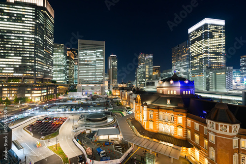 Business concept for real estate and corporate construction - panoramic modern city skyline bird eye aerial night view with tokyo station under dramatic glow and beautiful dark blue sky in Tokyo,Japan © voyata