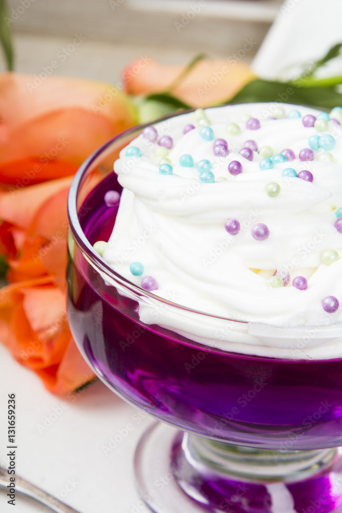 Colorful jelly with whipped cream and candy topping Colorful jelly with whipped cream and candy topping