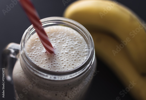 Healthy smoothie on gray background. Banana,oats,chia seeds and honey mix. 