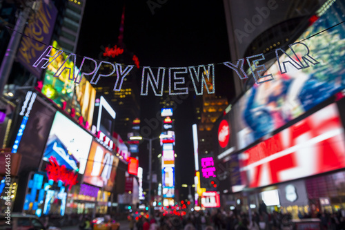 Glittery Happy New Year message strung across the flashing lights of Times Square, New York City