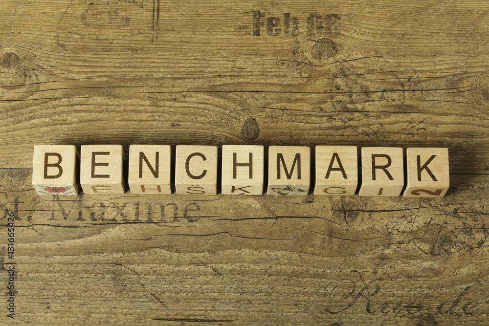 benchmark word on cubes on wooden background