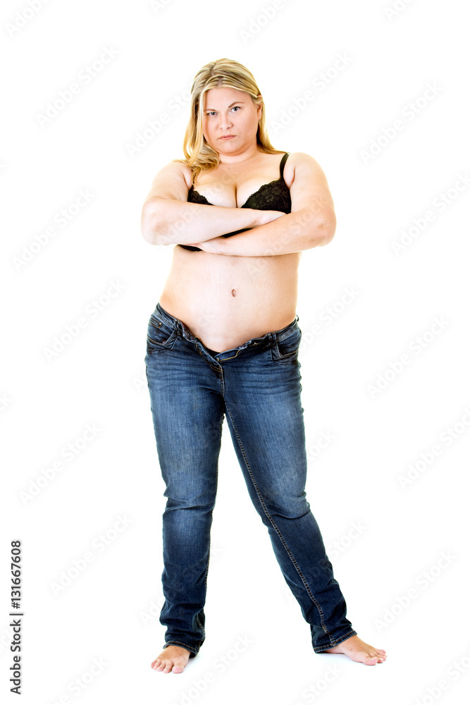 Overweight young woman in bra and jeans on white. Overweight young woman in bra and jeans on white.