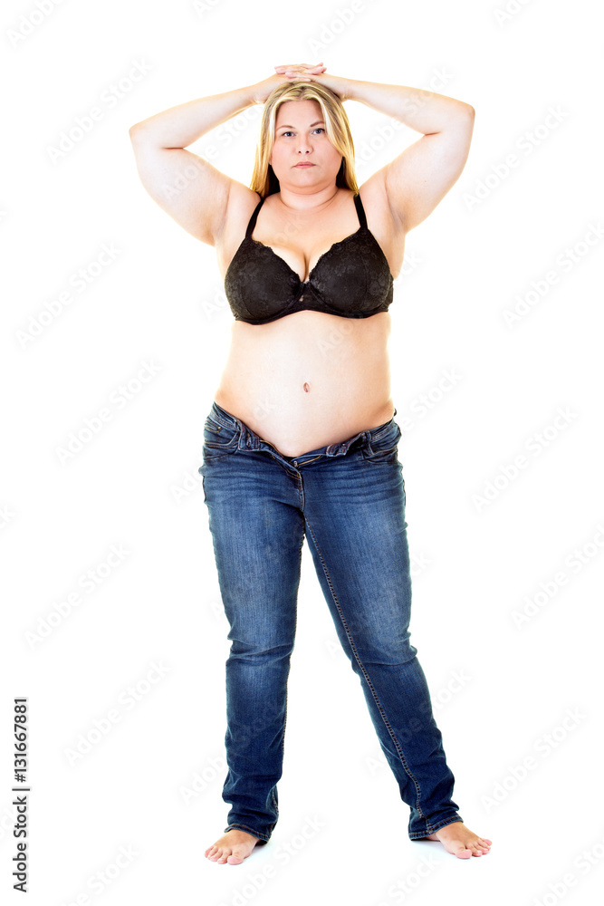 Large young woman in bra and jeans on white. Large young woman in bra and jeans on white.