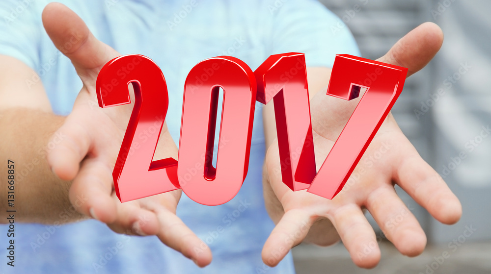 Businessman holding 2017 3D rendering text Businessman holding 2017 3D rendering text