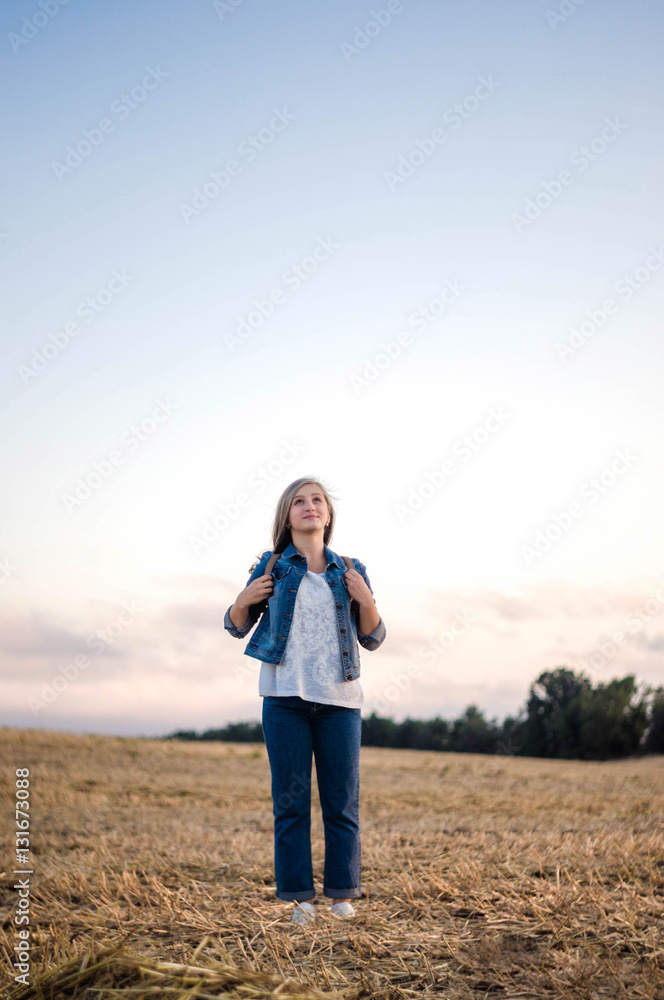 Girl on field with beveled wheat 