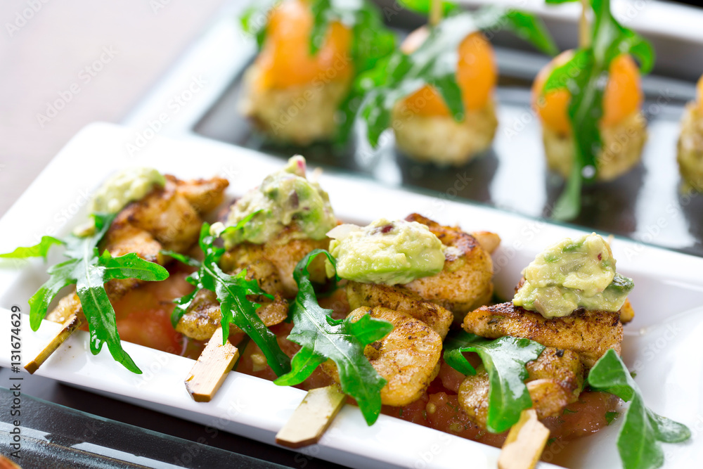 set of finger food - chicken skewers with guacamole set of finger food - chicken skewers with guacamole