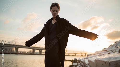 Young stylish woman walking in urban street