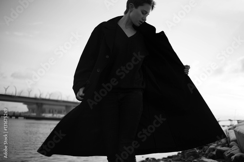 Young stylish woman walking in urban street