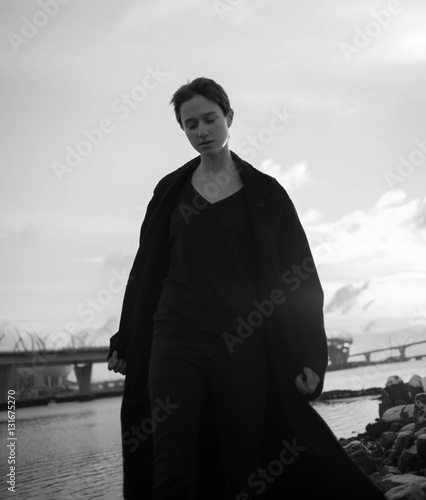 Young stylish woman walking in urban street