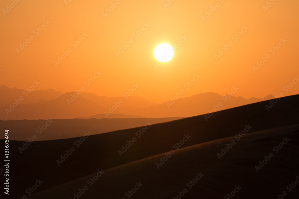 Hot sunrise in the desert dunes of Dubai, United Arab Emirates.