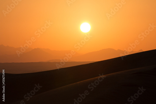 Hot sunrise in the desert dunes of Dubai, United Arab Emirates.